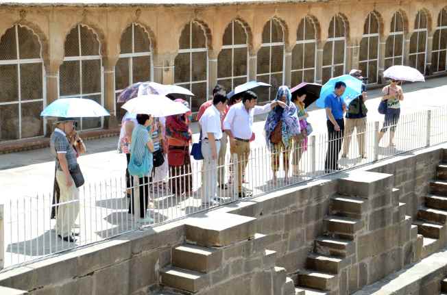 Tourists and visitors watching Abhaneri Stepwells from the top.